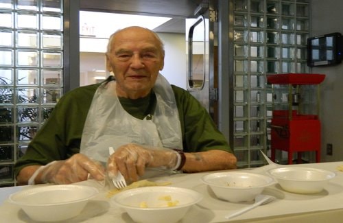 Harold Hixon enjoys making chalupas during Homeland's cooking class
