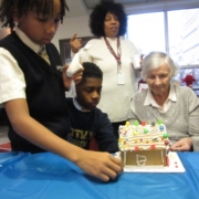 Homeland Center resident and Nativity School students decorating gingerbread houses