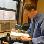 'ed savage reviewing images to be printed in the homeland lottery calendar'