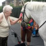 'Homeland resident Isabelle Smith petting bridget the horse'