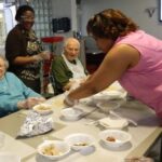 'Speech therapist Shayla Oaks-Rester looks on as activities coordinator Anita Payne sets out ingredients for residents Doris Gingrich and Harold Hixon'
