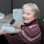 'hospice volunteer Claudia Diane Brown working at a desk'