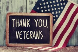 sign reading 'thank you veterans' next to an american flag