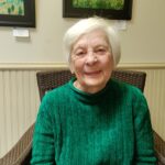 'Board of Managers member Babs Phillips in an armchair'