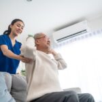'a nurse helping a patient with physical exercise'
