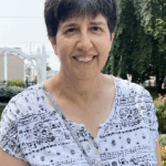 'board of managers member sue zaccano smiling outside of Homeland Center'