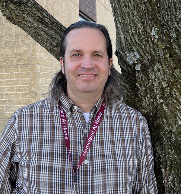 Homeland Chaplain Todd Carver smiling next to a tree