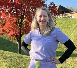 Homeland Hospice CNA Angie Bucci smiling in front of a tree