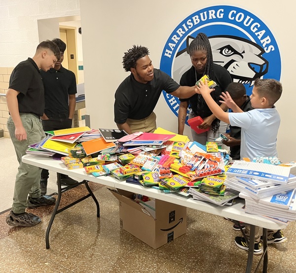 students going through supplies at the back to school drive