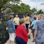 'a group of visitors at the tribute medallion unveiling'