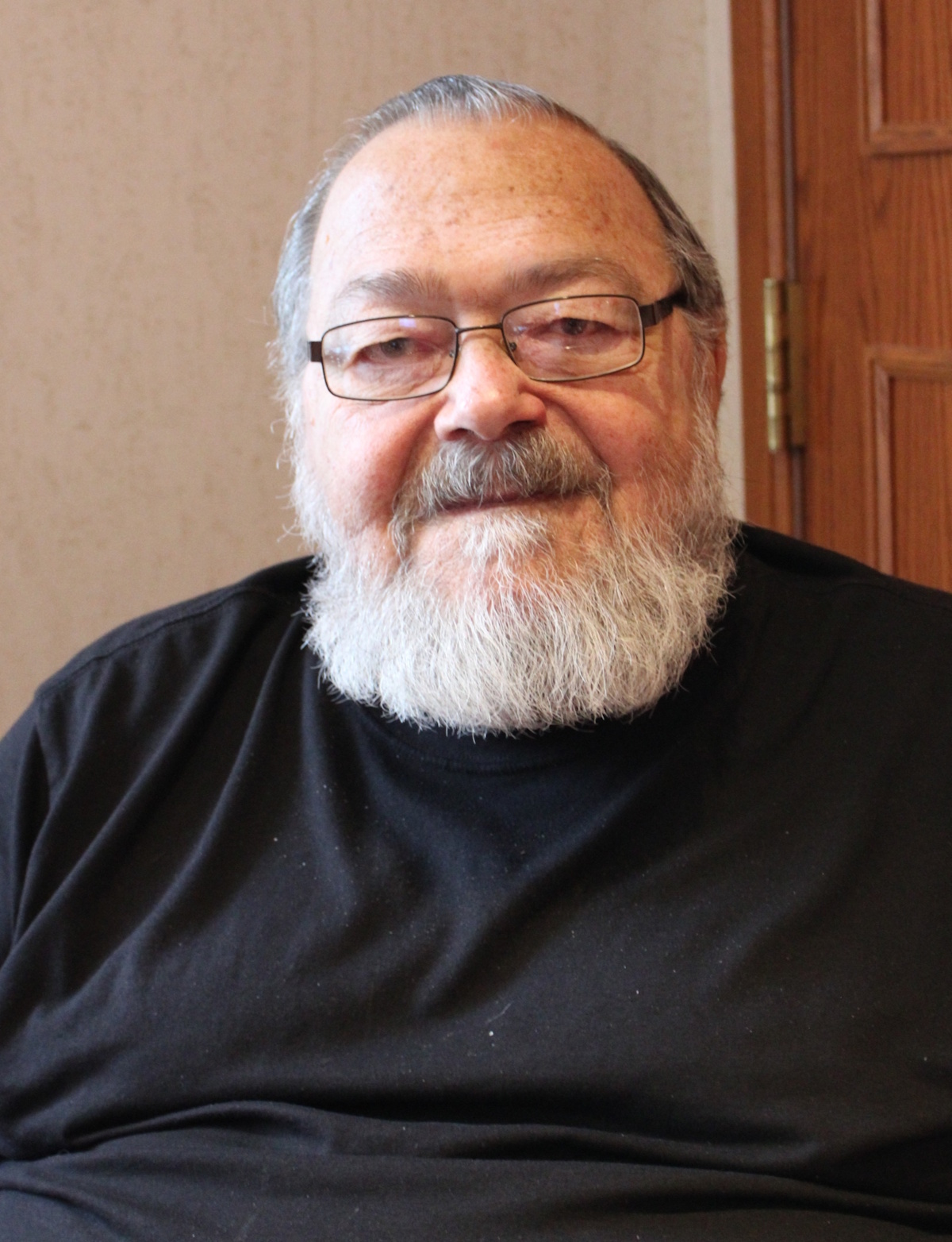 resident joe pulaski sitting in his room at homeland center