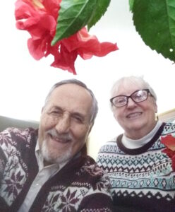 Joyce and Mehrdad Zandieh smiling together next to flowers