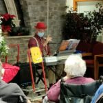'lee playing music in front of homeland residents'
