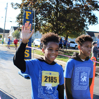 'two 5k participants crossing the finish line'