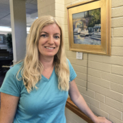 Artist Kelly Charlesworth next to one of her pieces