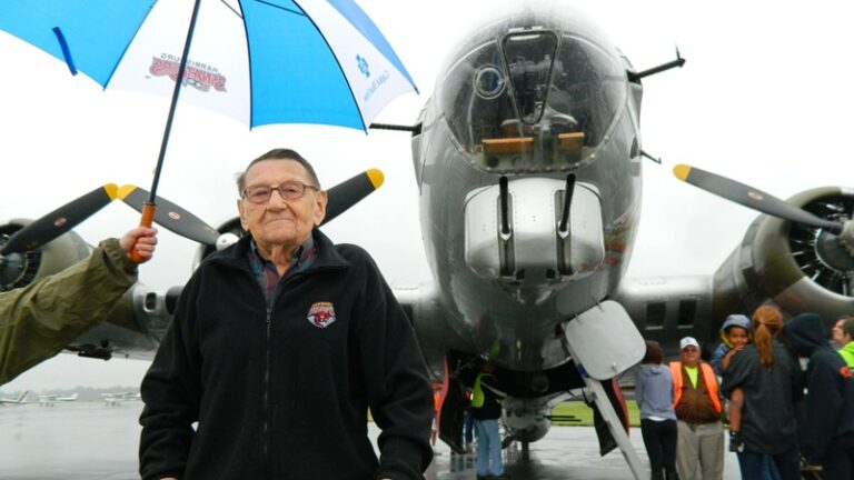 Joe Bowers standing by the Aluminum Overcast, a B-17