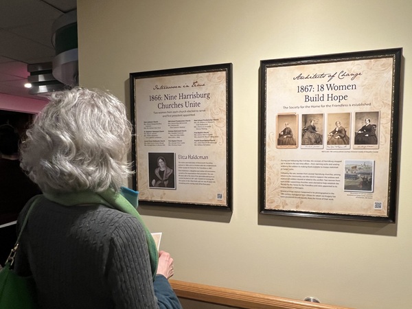 visitor reading a display in the tribute hallway